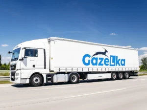 Biała ciężarówka MAN TGX GAZeLka jadąca drogą